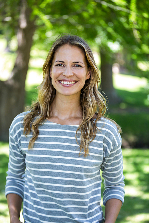 Portrait of a smiling woman in a park