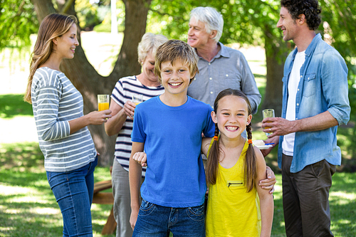 Smiling family standing in a park