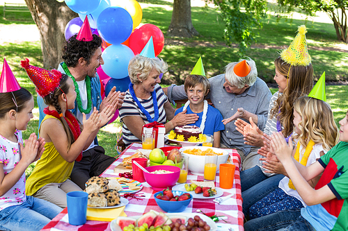 Happy family celebrating a birthday in the park