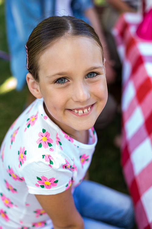 Smiling little girl at birthday party in the park