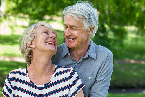 Senior couple embracing in park