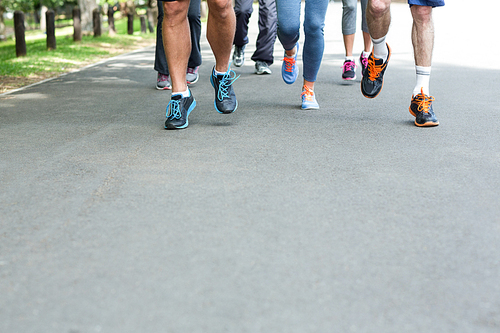 Cropped view of marathon athletes feet running on the street