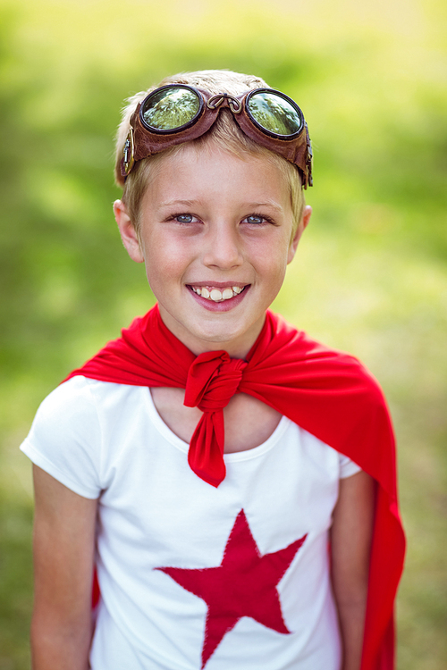 Little boy pretending to be superhero in park