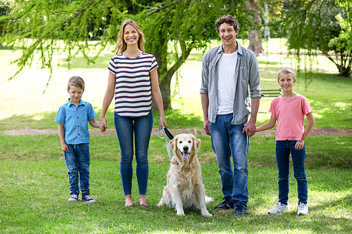 Family with dog in the park on a sunny day