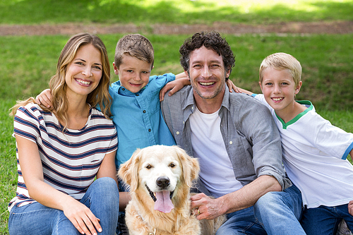 Family with dog in the park on a sunny day