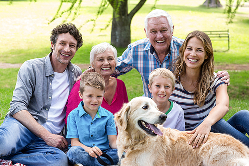 Family with dog in the park on a sunny day