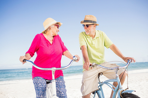 Senior couple going for a bike ride on the beach