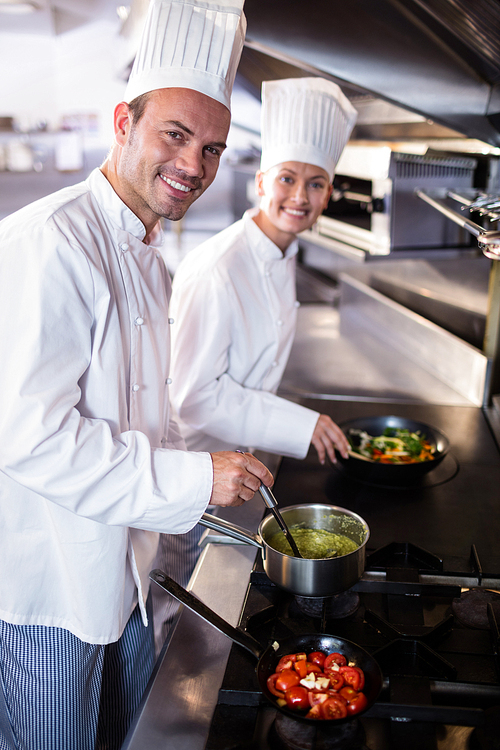 Portrait of chef preparing food in the kitchen of a restaurant
