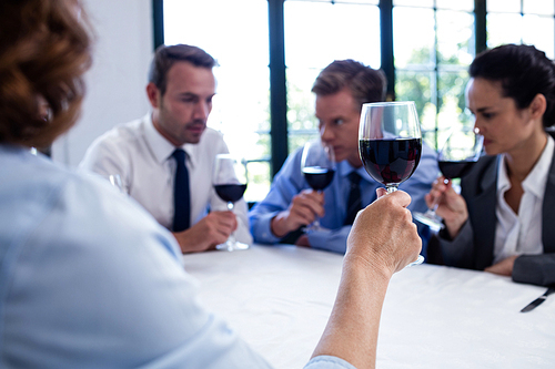 Group of businesspeople drinking wine glass during business lunch meeting in a restaurant