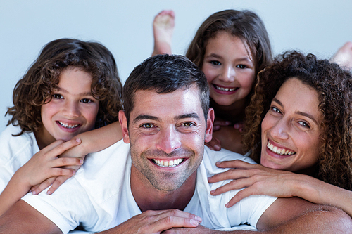 Portrait of a family lying on bed at home