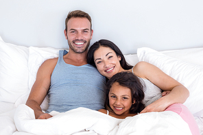 Happy family in their bedroom at home