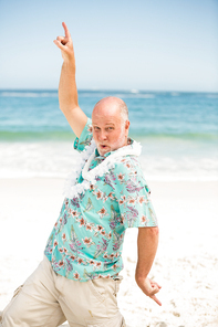 Senior man dancing at the beach on a sunny day