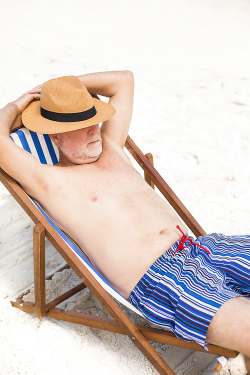 Senior man lying in a sunchairon a sunny day