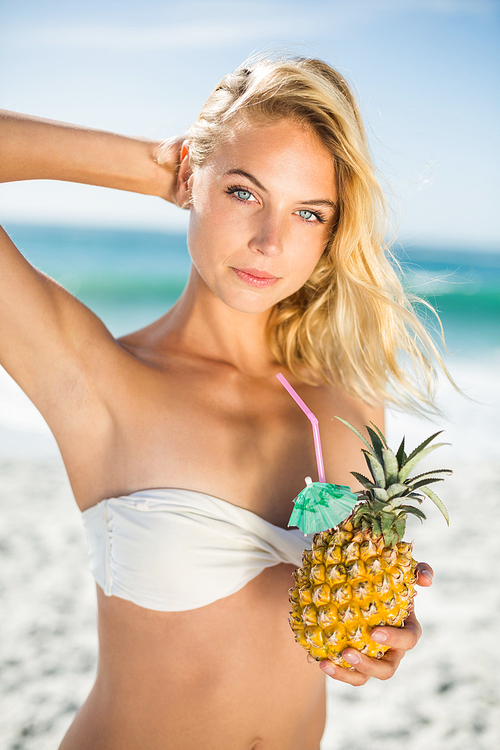 Woman holding a pineapple on a sunny day