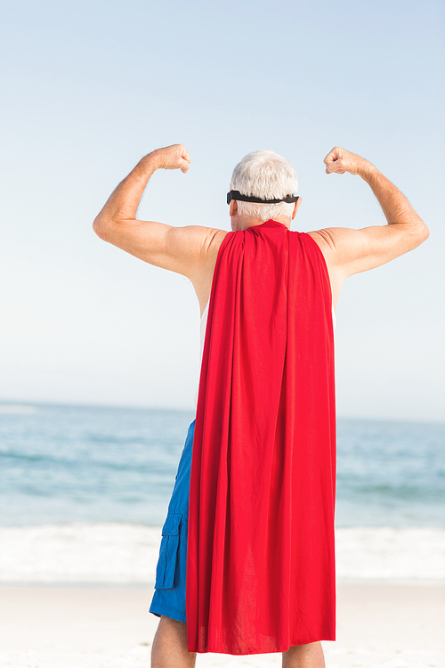 Senior man pretending to be a superhero on a sunny day