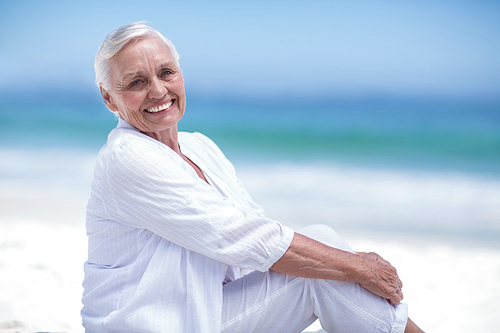 Beautiful mature woman posing at the beach