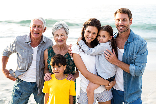 Happy family posing at the beach on a sunny day