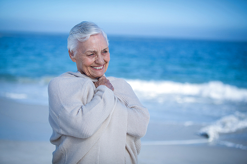Senior woman relaxing at the beach on a sunny day