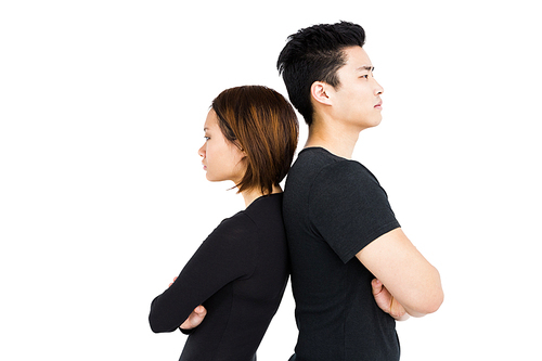 Depressed couple standing back to back on white background