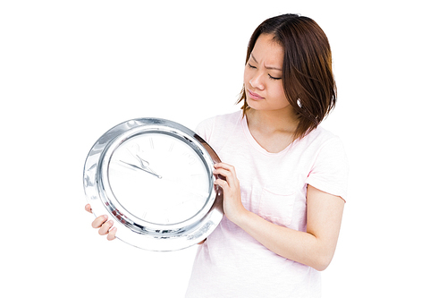 Young woman holding stainless steel clock on white background