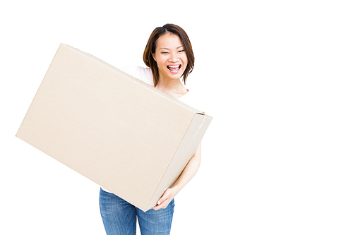 Cheerful young woman holding a cardboard box on white background