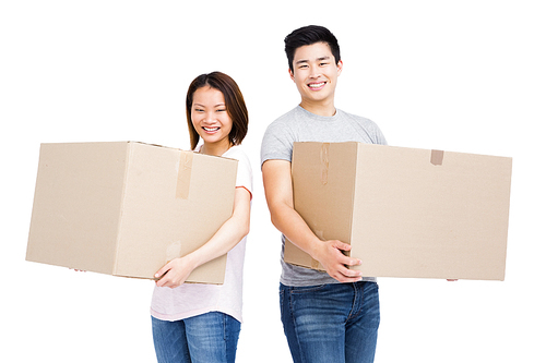 Young couple holding cardboard boxes on white background