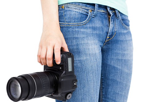 Woman holding a camera on white background