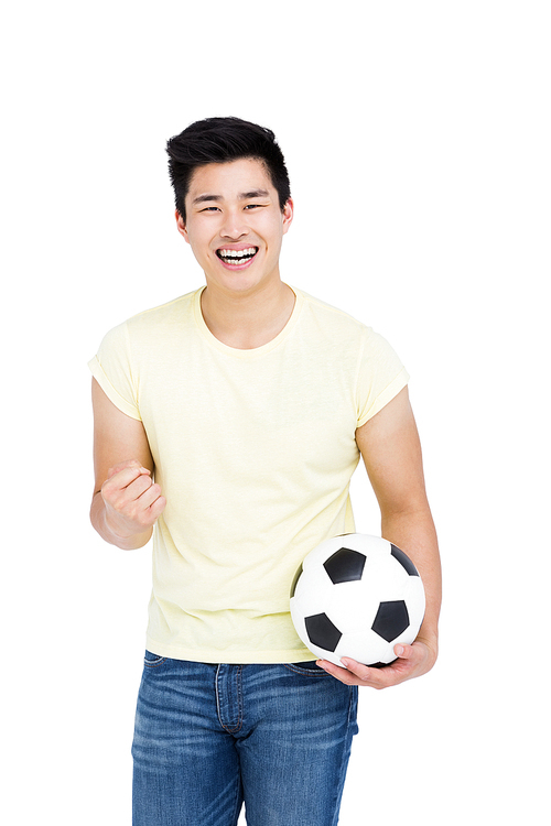 Portrait of a happy man holding football and smiling on white background