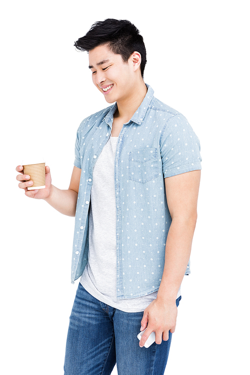 Young man holding a disposable cup on white background