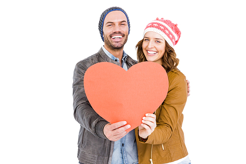 Portrait of happy young couple holding heart on white background