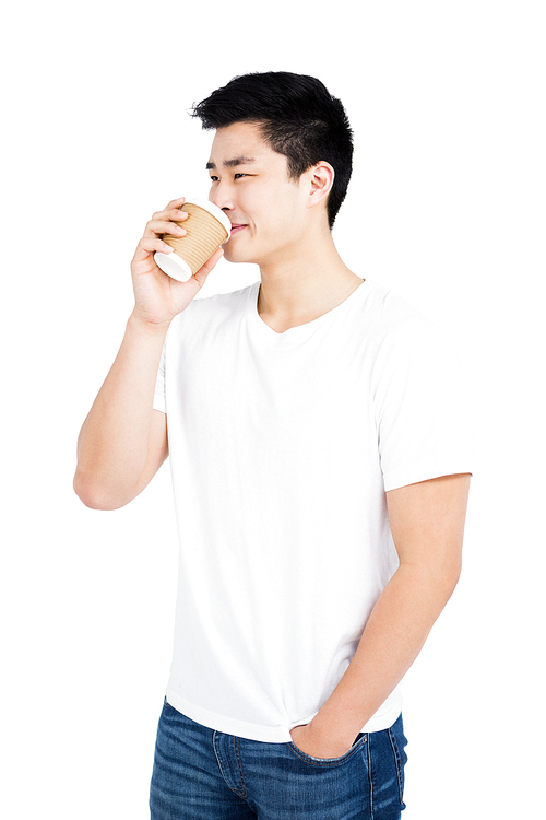 Close-up of young man drinking coffee from a disposable cup on white background