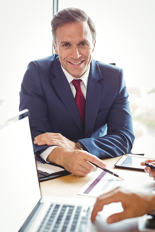 Portrait of businessman interacting in conference room