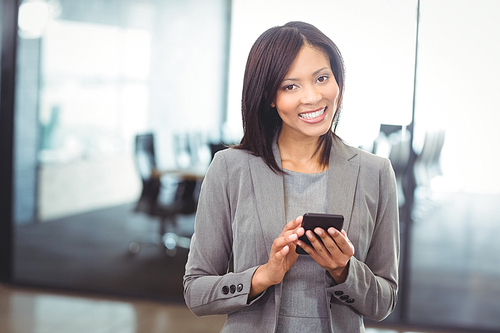 Portrait of attractive businesswoman using mobile phone