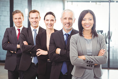 Portrait of businesspeople standing with arms crossed in office