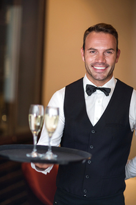 Waiter smiling at camera in a commercial kitchen