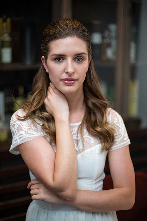 Portrait of serious woman standing at restaurant