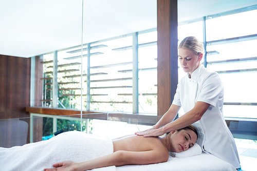 Woman receiving a back massage at spa