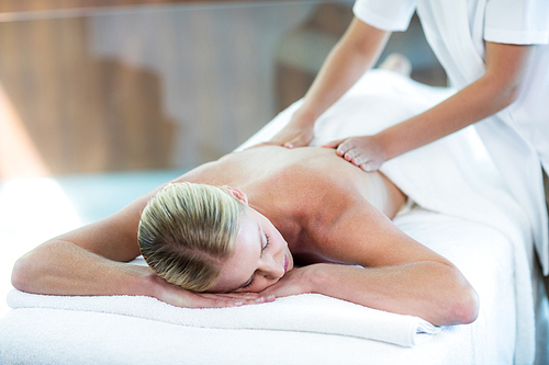 Woman receiving a back massage at spa