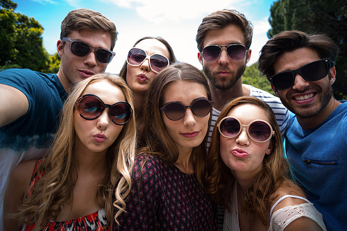 Happy friends posing for a selfie on a sunny day