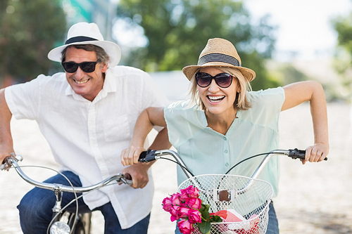 Portrait smiling couple ridding bike together