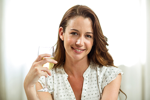 Portrait of woman holding wine glass at home