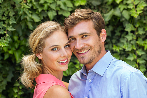 Portrait of happy romantic couple at front yard
