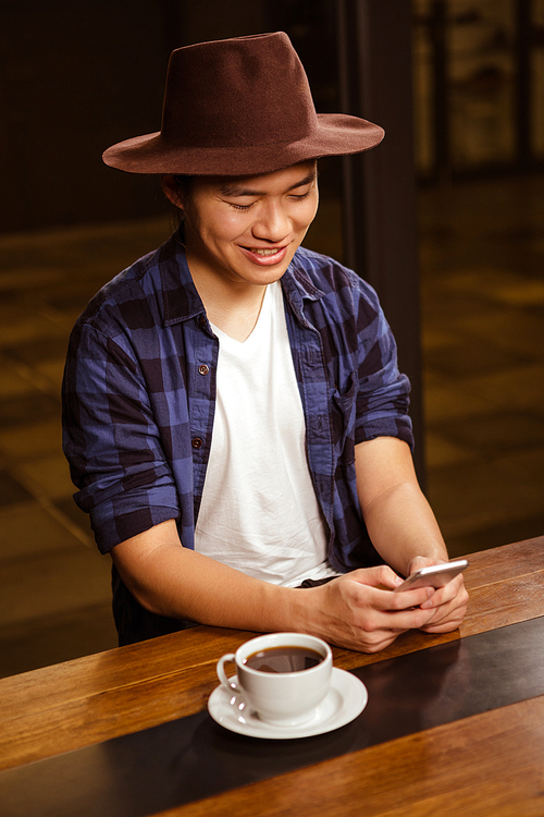 Man using a smartphone in a coffee shop