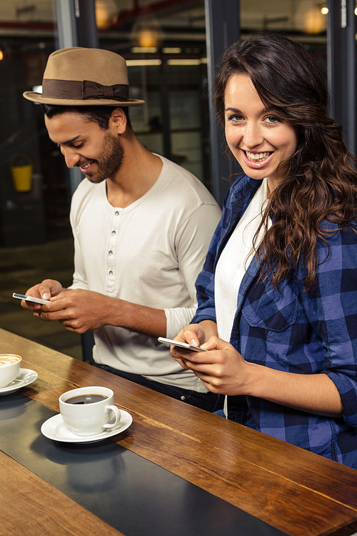 Couple using smartphones in a coffee shops