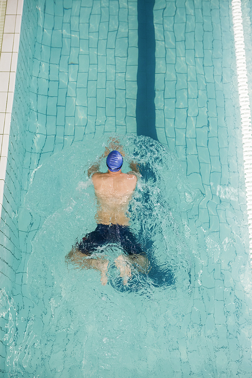 Swimmer doing the breaststroke in swimming pool at leisure center
