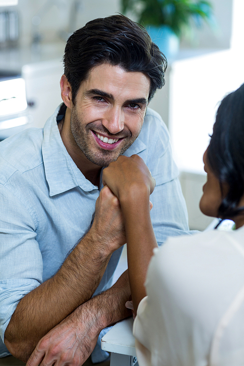 Portrait of happy man holding hand of a woman at home