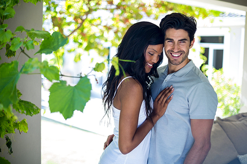 Young couple embracing each other at home