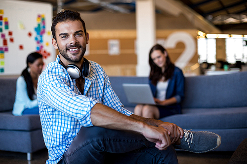 Young man smiling at camera in the office