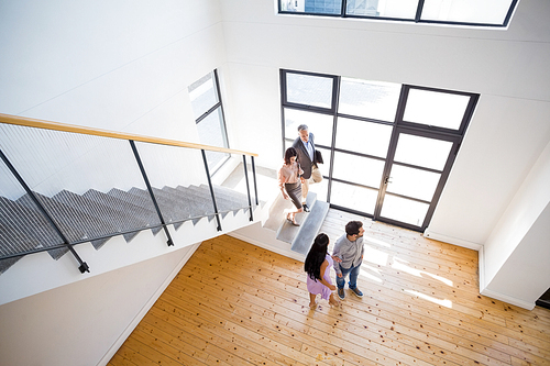 Real estate agent showing new house to couple