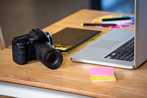 유토이미지 | Camera, sticky notes, graphics tablet and laptop at desk in office